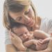 woman in white crew neck t-shirt carrying baby